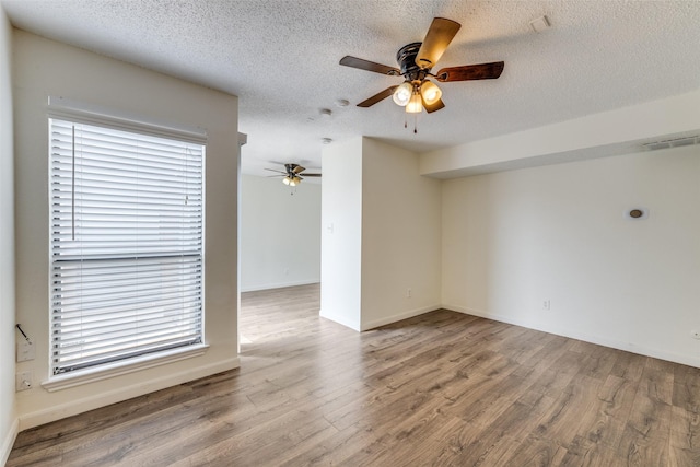 2301 Balsam Dr Unit F308, Arlington, TX 76006 - spare room featuring wood finished floors, a ceiling fan, a textured ceiling, and baseboards
