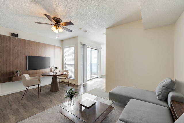 2301 Balsam Dr Unit F308, Arlington, TX 76006 - living area featuring a ceiling fan, wood finished floors, and a textured ceiling