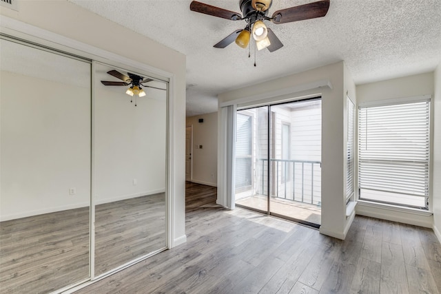 2301 Balsam Dr Unit F308, Arlington, TX 76006 - empty room featuring ceiling fan, wood finished floors, baseboards, and a textured ceiling