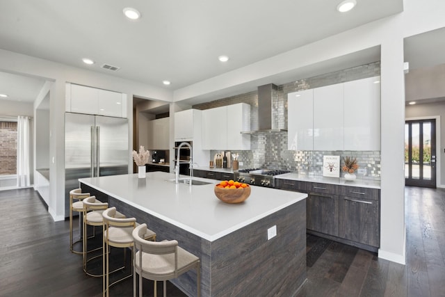 3967 Sanders Dr, Celina, TX 75009 - kitchen featuring modern cabinets, wall chimney exhaust hood, a sink, dark wood-type flooring, and stainless steel built in fridge