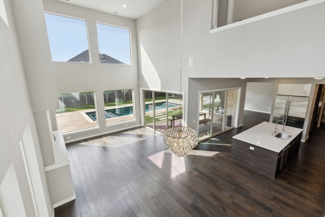 3967 Sanders Dr, Celina, TX 75009 - living room featuring a high ceiling, dark wood finished floors, baseboards, a chandelier, and recessed lighting