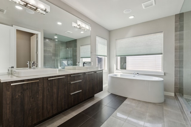 3967 Sanders Dr, Celina, TX 75009 - bathroom featuring a tile shower, double vanity, a freestanding tub, recessed lighting, and tile patterned floors