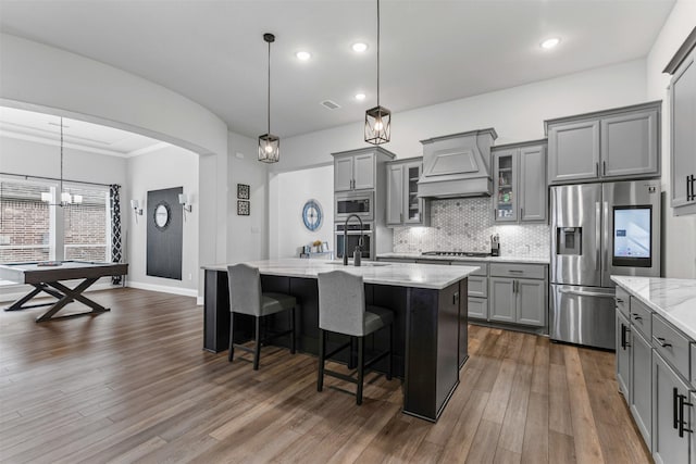 1318 Middleton Dr, Rockwall, TX 75087 - kitchen with appliances with stainless steel finishes, gray cabinets, custom range hood, dark wood-style floors, and recessed lighting