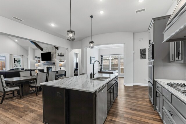 1318 Middleton Dr, Rockwall, TX 75087 - kitchen featuring a sink, appliances with stainless steel finishes, premium range hood, vaulted ceiling, and dark wood-type flooring