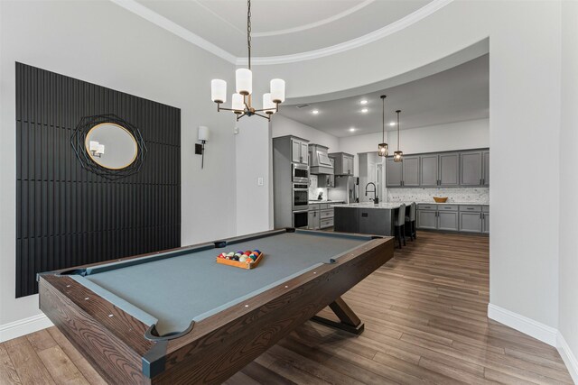 1318 Middleton Dr, Rockwall, TX 75087 - game room with dark wood finished floors, pool table, a chandelier, a towering ceiling, and baseboards