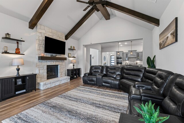 1318 Middleton Dr, Rockwall, TX 75087 - living area featuring ceiling fan, wood finished floors, beam ceiling, a fireplace, and high vaulted ceiling