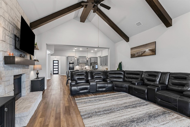 1318 Middleton Dr, Rockwall, TX 75087 - living room with a fireplace, a ceiling fan, hardwood / wood-style flooring, beam ceiling, and high vaulted ceiling