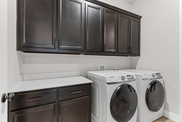 1318 Middleton Dr, Rockwall, TX 75087 - laundry area with cabinet space, washing machine and dryer, and baseboards