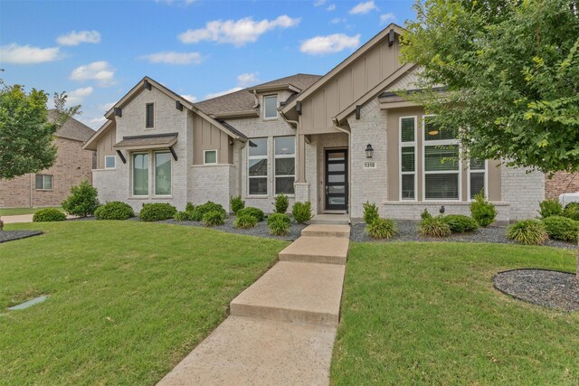 1318 Middleton Dr, Rockwall, TX 75087 - view of front of property with board and batten siding, a front lawn, and brick siding
