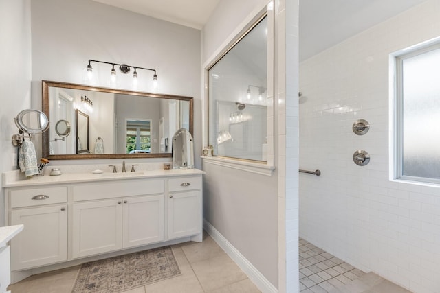 821 Mildren Ln, Fate, TX 75087 - bathroom with vanity, tile patterned flooring, a walk in shower, and healthy amount of natural light