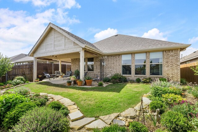 821 Mildren Ln, Fate, TX 75087 - back of house with brick siding, a patio area, and a shingled roof