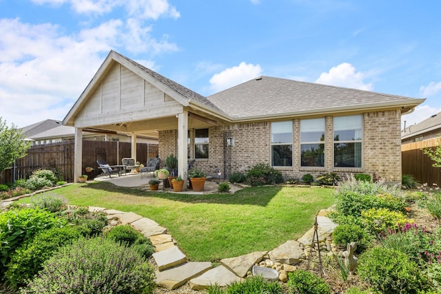 821 Mildren Ln, Fate, TX 75087 - rear view of house with brick siding, a patio area, and roof with shingles