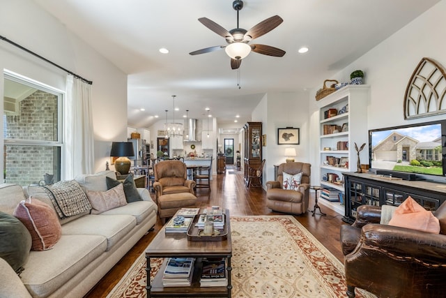 821 Mildren Ln, Fate, TX 75087 - living room with dark wood-style flooring, ceiling fan, recessed lighting, and a chandelier
