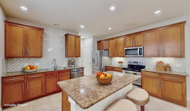 6407 Capulet Pl, Dallas, TX 75252 - kitchen featuring appliances with stainless steel finishes, backsplash, a breakfast bar area, light tile patterned floors, and recessed lighting