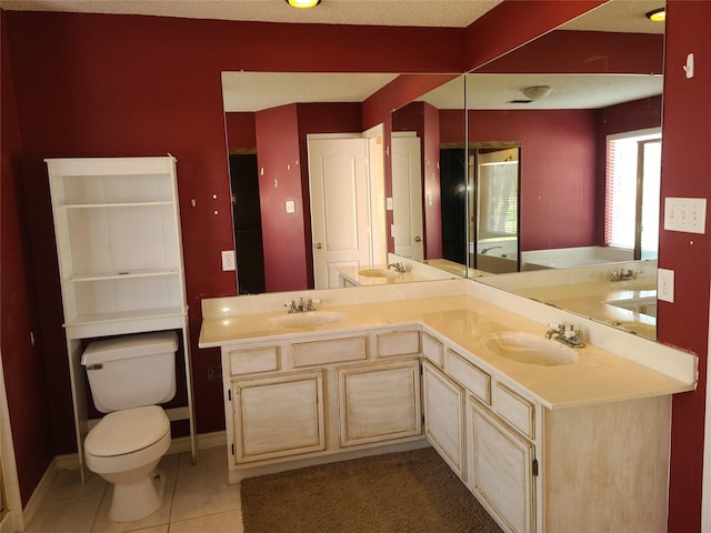 bathroom featuring tile patterned floors, toilet, double vanity, and baseboards