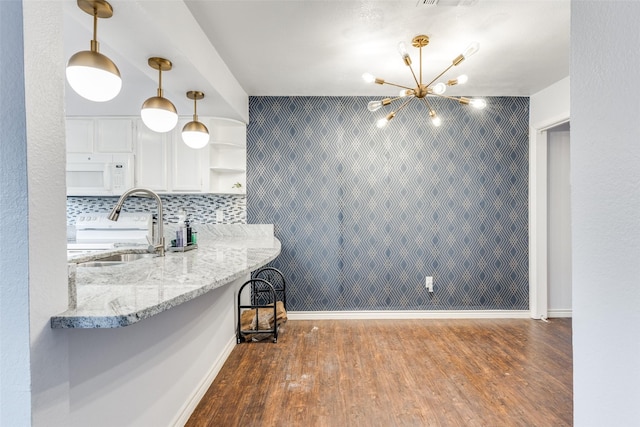 2330 Kennington Dr Unit D, Arlington, TX 76012 - kitchen featuring white microwave, a sink, wood finished floors, and white cabinetry