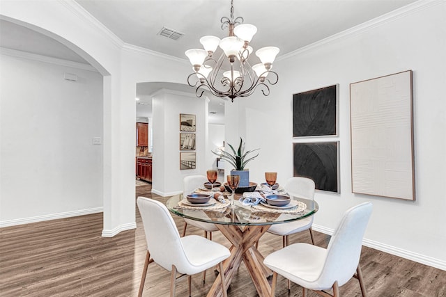 1600 Templegate Dr, Mckinney, TX 75072 - dining area featuring arched walkways, wood finished floors, a chandelier, crown molding, and baseboards