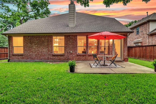 1600 Templegate Dr, Mckinney, TX 75072 - back of house at dusk with brick siding, a shingled roof, and a chimney