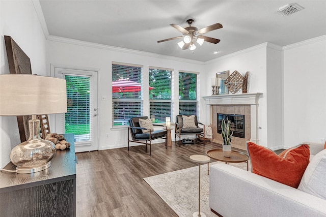1600 Templegate Dr, Mckinney, TX 75072 - living area with ornamental molding, a ceiling fan, wood finished floors, a tile fireplace, and baseboards