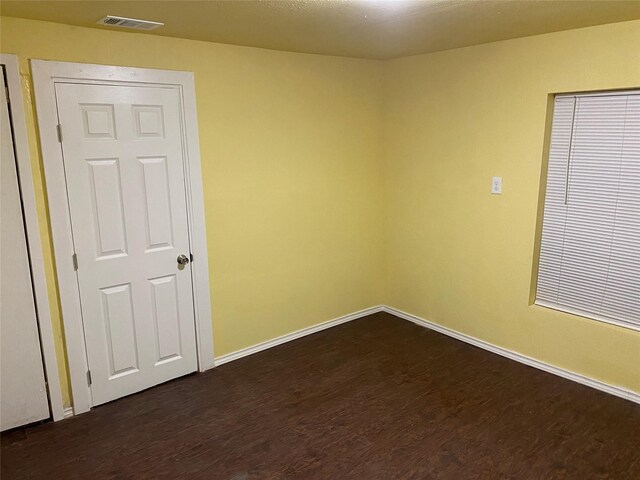 7002 Red Bud Dr, Dallas, TX 75227 - empty room with dark wood-style flooring and baseboards