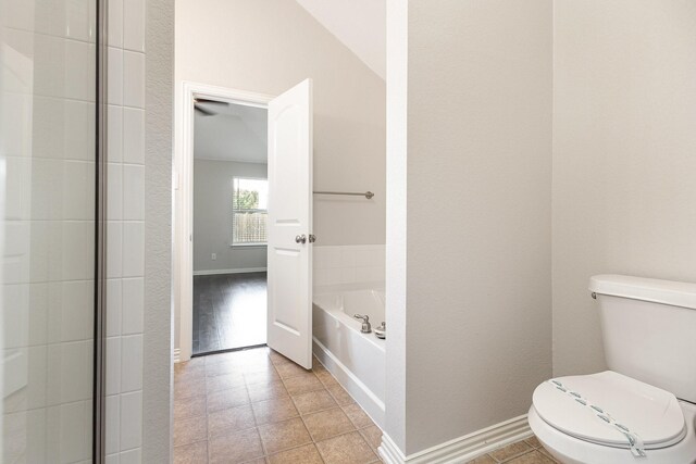 213 Longhorn Dr, Waxahachie, TX 75165 - bathroom featuring toilet, a bath, tile patterned floors, and baseboards