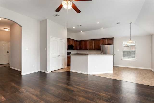 213 Longhorn Dr, Waxahachie, TX 75165 - kitchen featuring freestanding refrigerator, lofted ceiling, arched walkways, a ceiling fan, and open floor plan