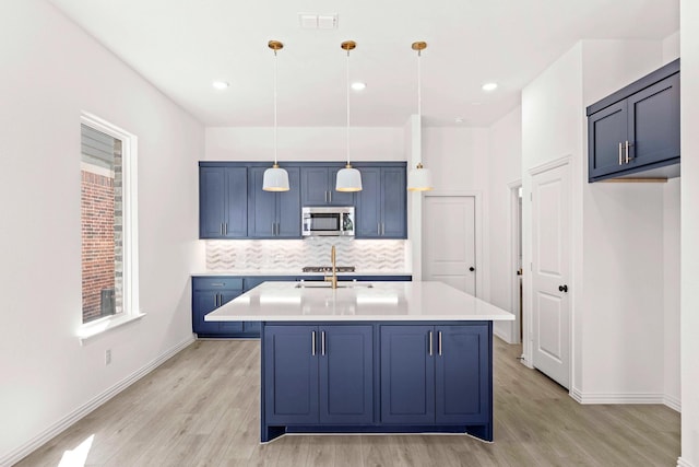 1126 Bexar Ln, Plano, TX 75075 - kitchen with stainless steel microwave, light wood finished floors, backsplash, light countertops, and recessed lighting