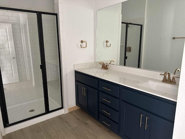 1126 Bexar Ln, Plano, TX 75075 - full bath with a stall shower, wood finished floors, and double vanity