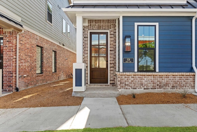 1126 Bexar Ln, Plano, TX 75075 - doorway to property with a standing seam roof and brick siding