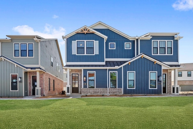 1126 Bexar Ln, Plano, TX 75075 - view of front facade with board and batten siding, brick siding, a front yard, and a standing seam roof