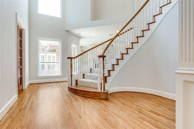 2 Birchmont Ln, Dallas, TX 75230 - entryway with wood finished floors, a towering ceiling, stairs, and baseboards