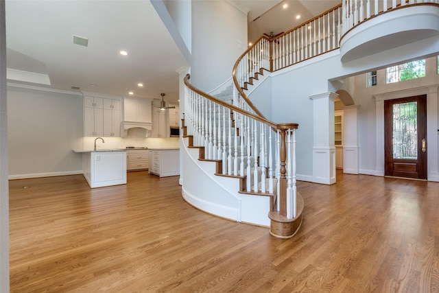 2 Birchmont Ln, Dallas, TX 75230 - entryway with arched walkways, light wood-style flooring, baseboards, stairway, and recessed lighting
