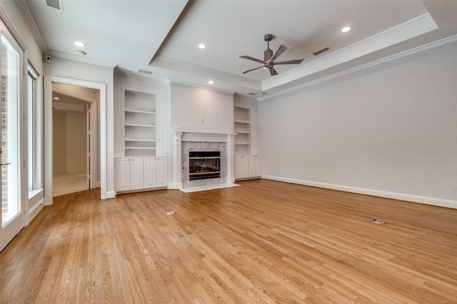 2 Birchmont Ln, Dallas, TX 75230 - unfurnished living room featuring built in shelves, ornamental molding, a ceiling fan, light wood-style floors, and a high end fireplace