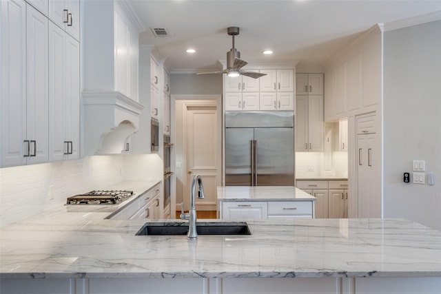 2 Birchmont Ln, Dallas, TX 75230 - kitchen with a sink, appliances with stainless steel finishes, a ceiling fan, decorative backsplash, and recessed lighting