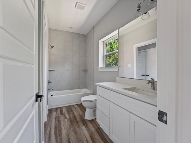 6223 Post Oak Ter, Fort Worth, TX 76112 - full bathroom with toilet, wood finished floors, vanity, and washtub / shower combination