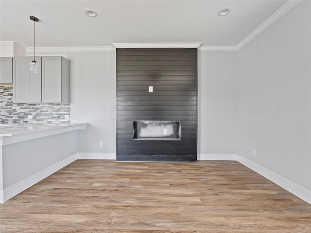6223 Post Oak Ter, Fort Worth, TX 76112 - unfurnished living room with ornamental molding, light wood-style flooring, a large fireplace, baseboards, and recessed lighting