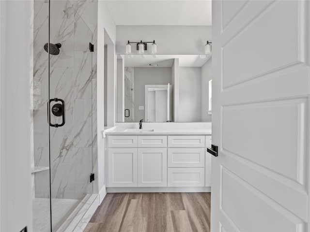 6223 Post Oak Ter, Fort Worth, TX 76112 - bathroom with a marble finish shower, vanity, and wood finished floors