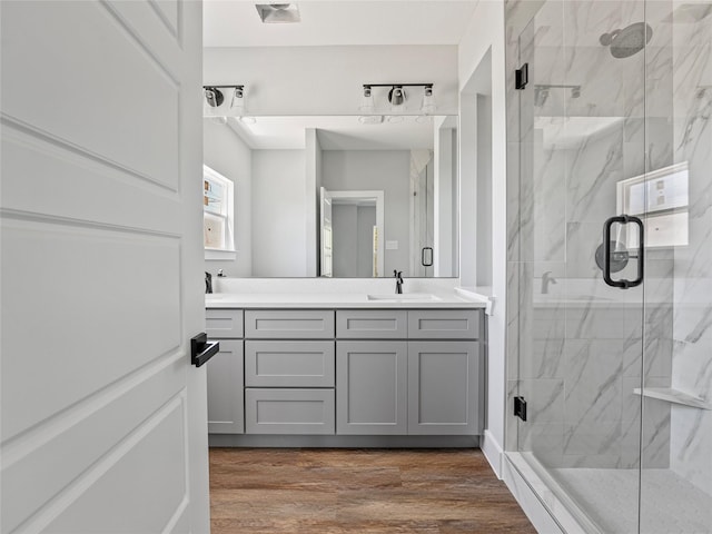 6223 Post Oak Ter, Fort Worth, TX 76112 - full bathroom featuring a marble finish shower, wood finished floors, and double vanity