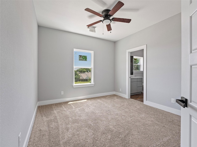 6223 Post Oak Ter, Fort Worth, TX 76112 - empty room featuring dark carpet, ceiling fan, and baseboards