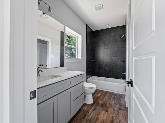 6223 Post Oak Ter, Fort Worth, TX 76112 - bathroom with toilet, wood finished floors, vanity, and shower / tub combination