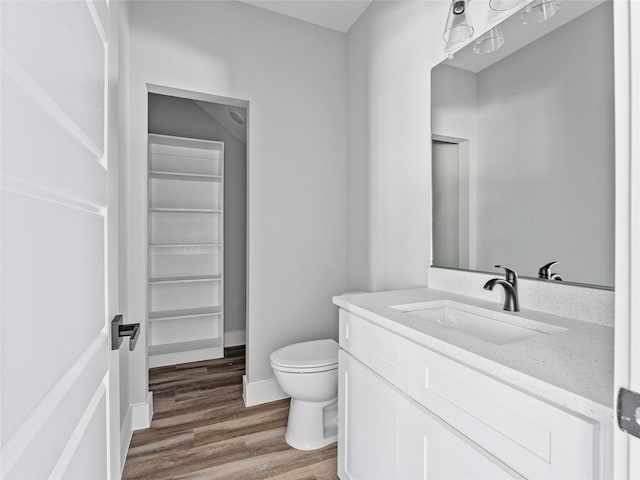 6223 Post Oak Ter, Fort Worth, TX 76112 - bathroom with toilet, wood finished floors, vanity, and baseboards