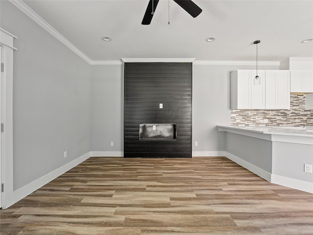 6223 Post Oak Ter, Fort Worth, TX 76112 - unfurnished living room featuring ceiling fan, a fireplace, ornamental molding, light wood finished floors, and baseboards