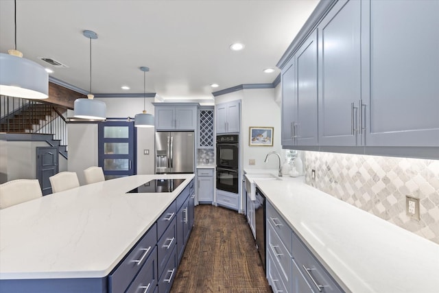 755 Richmond Ln, Keller, TX 76248 - kitchen featuring black appliances, backsplash, recessed lighting, a spacious island, and hanging light fixtures