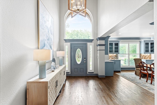 755 Richmond Ln, Keller, TX 76248 - entryway with a chandelier, dark wood finished floors, a textured wall, and a towering ceiling