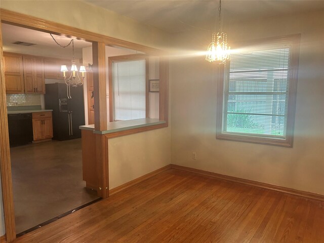 3415 Reily Ln, Shreveport, LA 71105 - unfurnished dining area featuring a chandelier, baseboards, and wood finished floors
