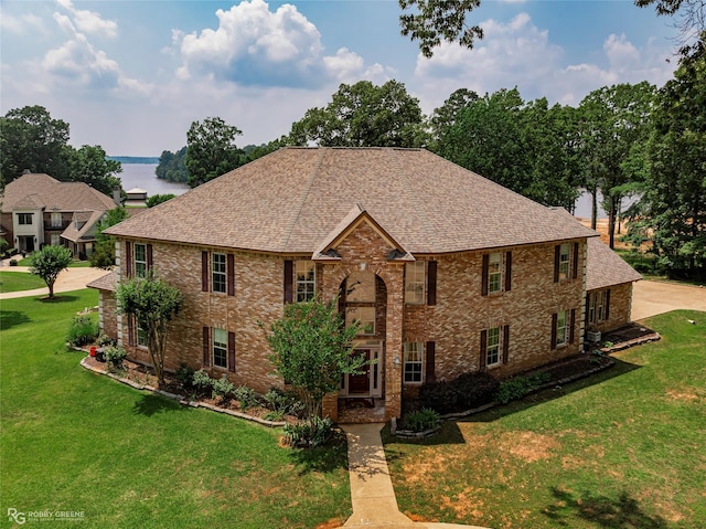 135 Oak Leaf Trl, Benton, LA 71006 - georgian-style home with roof with shingles, a front lawn, and brick siding