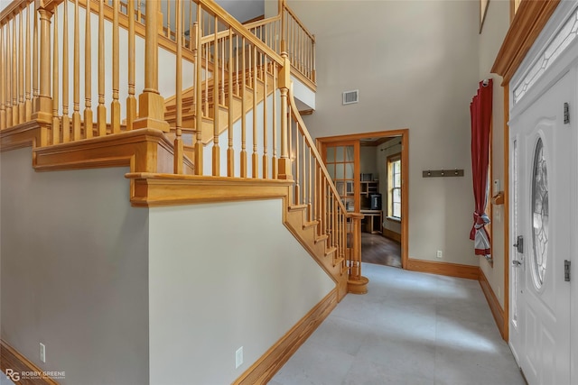 135 Oak Leaf Trl, Benton, LA 71006 - entryway featuring a high ceiling, stairs, and baseboards