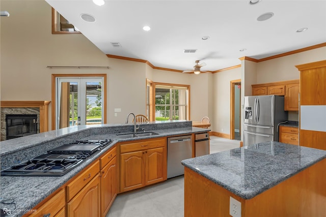 135 Oak Leaf Trl, Benton, LA 71006 - kitchen with appliances with stainless steel finishes, dark stone counters, a sink, a ceiling fan, and crown molding