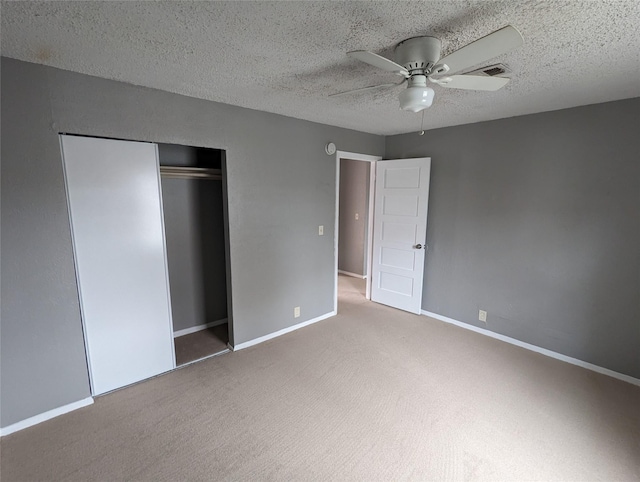1322 Caldwell Ave, Dallas, TX 75223 - unfurnished bedroom with carpet flooring, a closet, a textured ceiling, ceiling fan, and baseboards