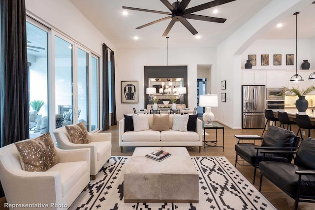 4621 Sandbrock Pkwy, Aubrey, TX 76227 - living room with light wood-type flooring, a chandelier, a ceiling fan, arched walkways, and recessed lighting